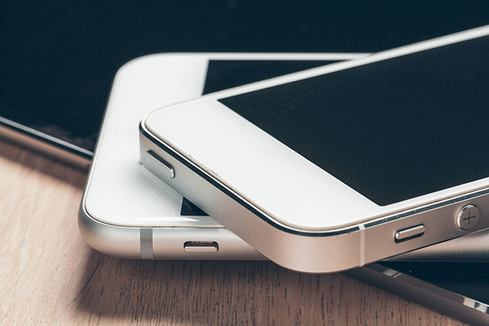 Stack of modern smartphones symbolizing employee distractions causing terminations
