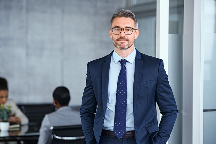 Confident businessman in office setting representing employees fired for ridiculous reasons