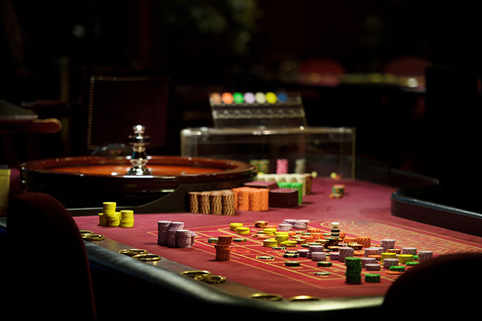 Casino roulette table with poker chips highlighting fired employees