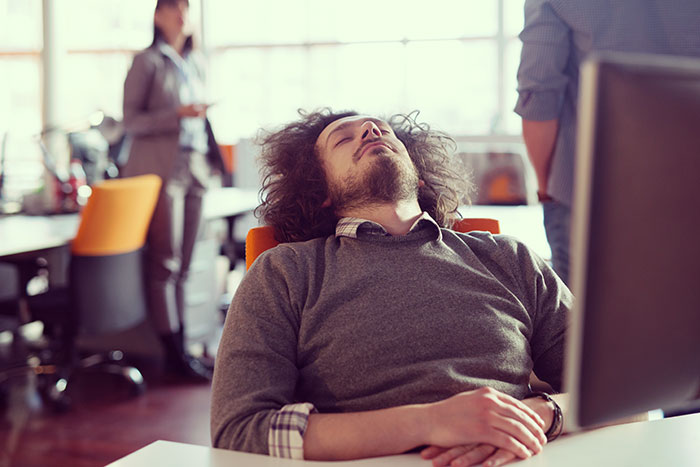 Employee sleeping at desk showing unprofessional behavior leading to firing