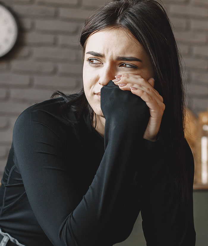 Woman looking upset reflecting on fake friend moments