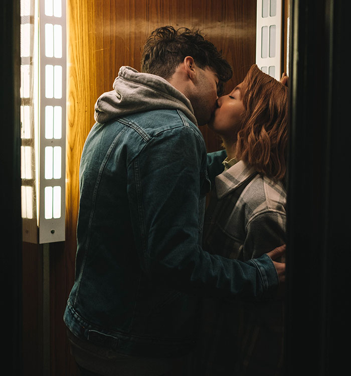 Couple kissing indoors, highlighting complex friendship realization moment