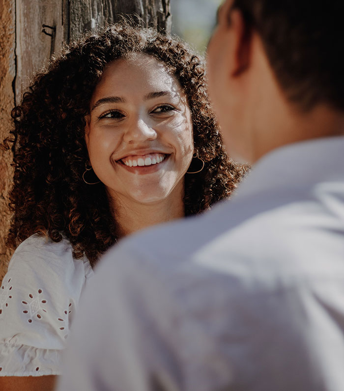 Woman smiling while discussing friendship moments