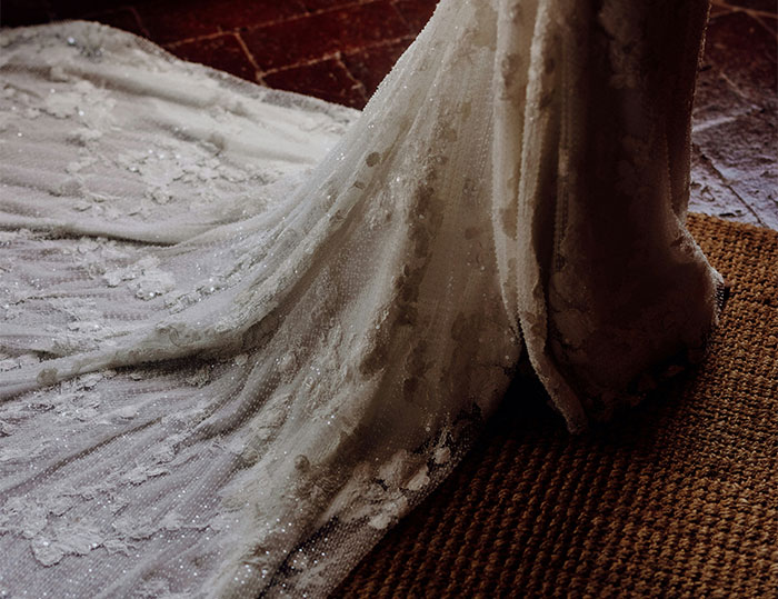 Close-up of a detailed wedding dress train with floral patterns
