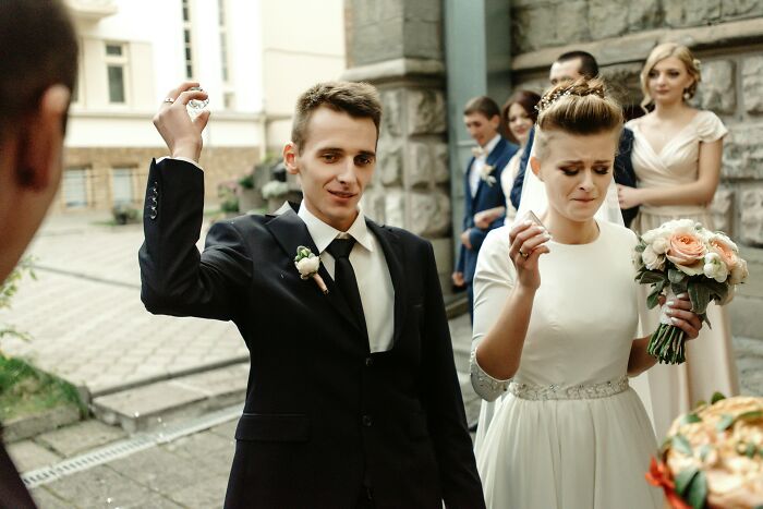 Groom and bride reacting awkwardly at wedding event