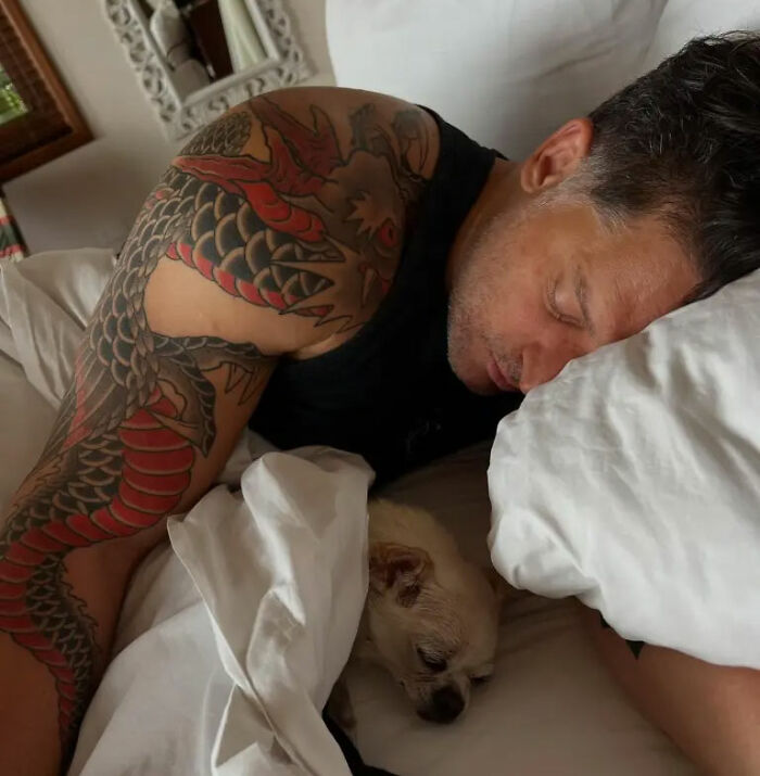Joe Manganiello sleeping in bed with a small dog nestled beside him, after revealing his health battle. Joe Manganiello sleeping in bed with a small dog nestled beside him, after revealing his health battle.