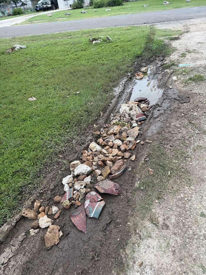 A muddy ditch filled with construction debris and water, illustrating a horrible landlord's neglect making a tenant's life miserable.