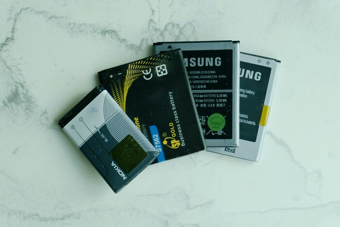 A collection of old phone batteries, a silly solution for recycling electronic waste.
