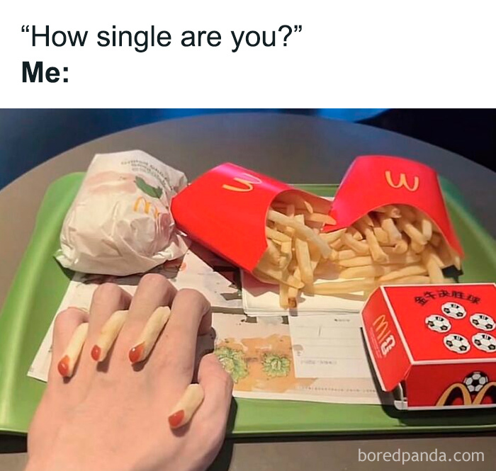 A relatable meme showing a hand with french fries on fingers and red nail polish, symbolizing being single.