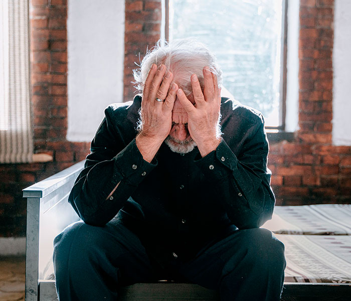 Elderly man displaying cancer symptoms often dismissed as normal aging or stress, covering his face with hands in distress. Elderly man displaying cancer symptoms often dismissed as normal aging or stress, covering his face with hands in distress.