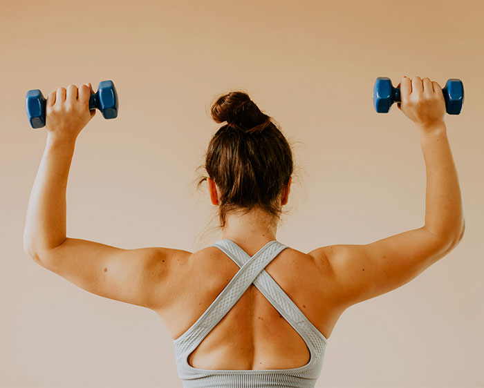 Fitness influencer showing how different body fat percentages transform the same face by exercising with dumbbells. Fitness influencer showing how different body fat percentages transform the same face by exercising with dumbbells.