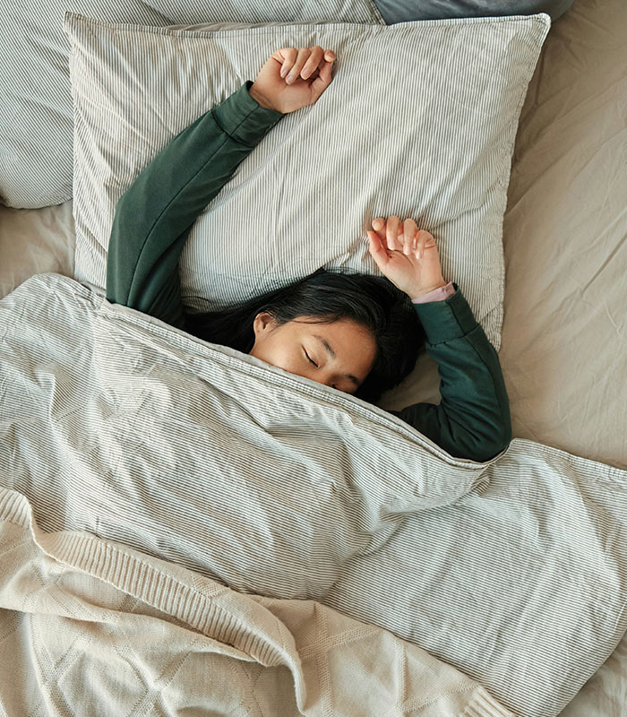 Person waking up, stretching in bed. Morning habits can be damaging your health, affecting cortisol levels. Person waking up, stretching in bed. Morning habits can be damaging your health, affecting cortisol levels.