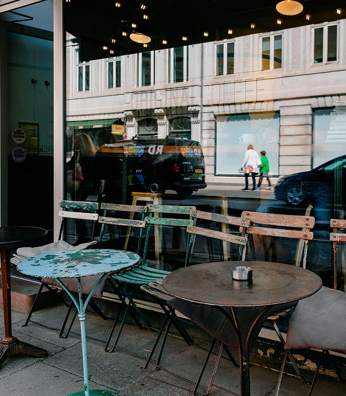 A reflection of a street scene in a large window, with two people and a van, highlighting the public space. A reflection of a street scene in a large window, with two people and a van, highlighting the public space.