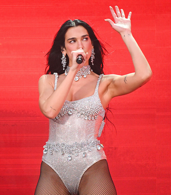 Dua Lipa performing, highlighting concern over SkinnyTok trends and online trolls. Dua Lipa performing, highlighting concern over SkinnyTok trends and online trolls.