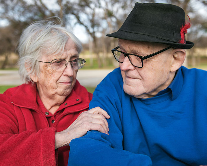Elderly married couple concerned about developing dementia under specific conditions.