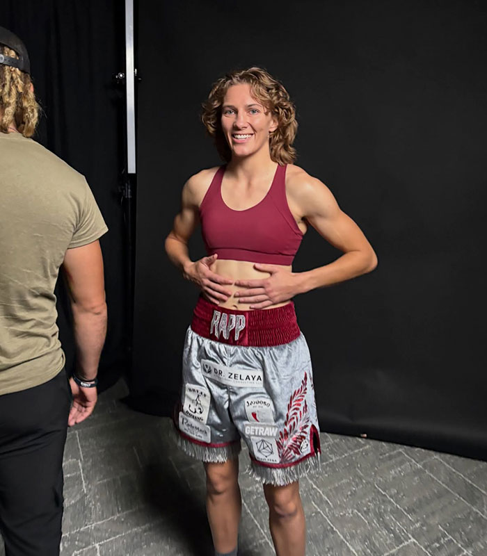Hannah Rapp smiling in boxing attire, ready for ring shopping and memorial tribute.
