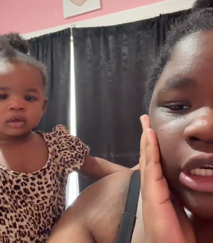 A young woman and a baby in a leopard print dress. The woman made a video giving up her baby. A young woman and a baby in a leopard print dress. The woman made a video giving up her baby.