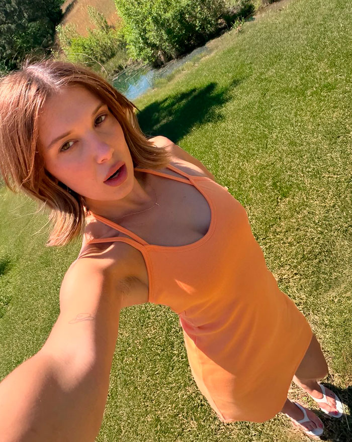 Millie Bobby Brown takes a sunny outdoor selfie, capturing fan attention with her casual, sheer look. Millie Bobby Brown takes a sunny outdoor selfie, capturing fan attention with her casual, sheer look.