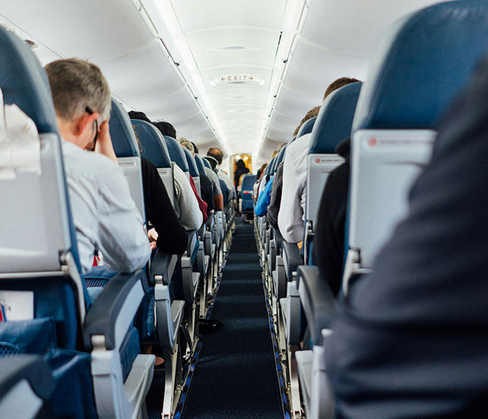 Airplane cabin with passengers, showing the experience of flights getting harder to handle due to turbulence. Airplane cabin with passengers, showing the experience of flights getting harder to handle due to turbulence.