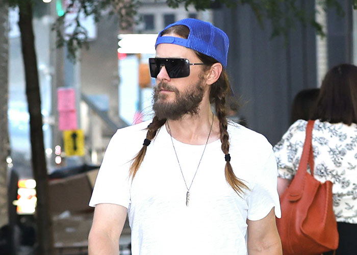 Jared Leto walking outdoors in a blue hat and sunglasses, amidst new predator allegations. Jared Leto walking outdoors in a blue hat and sunglasses, amidst new predator allegations.