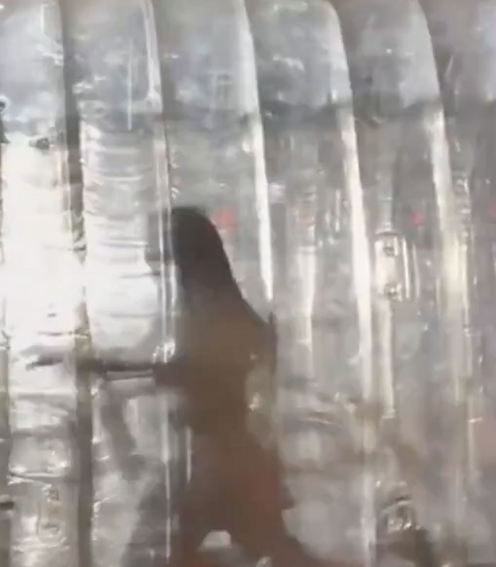 Katy Perry's silhouette trapped inside a giant plastic bottle after a bizarre stunt.