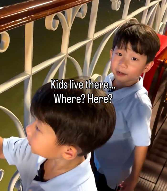 Two young boys on a boat looking over a railing, with one asking, Kids live there... Where? Here? discovering human bones. Two young boys on a boat looking over a railing, with one asking, Kids live there... Where? Here? discovering human bones.