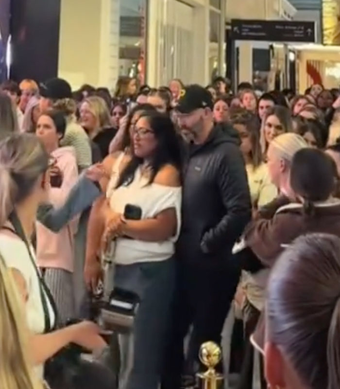 A crowd of people watching intently, symbolizing public shaming and a woman's scheme failing. A crowd of people watching intently, symbolizing public shaming and a woman's scheme failing.
