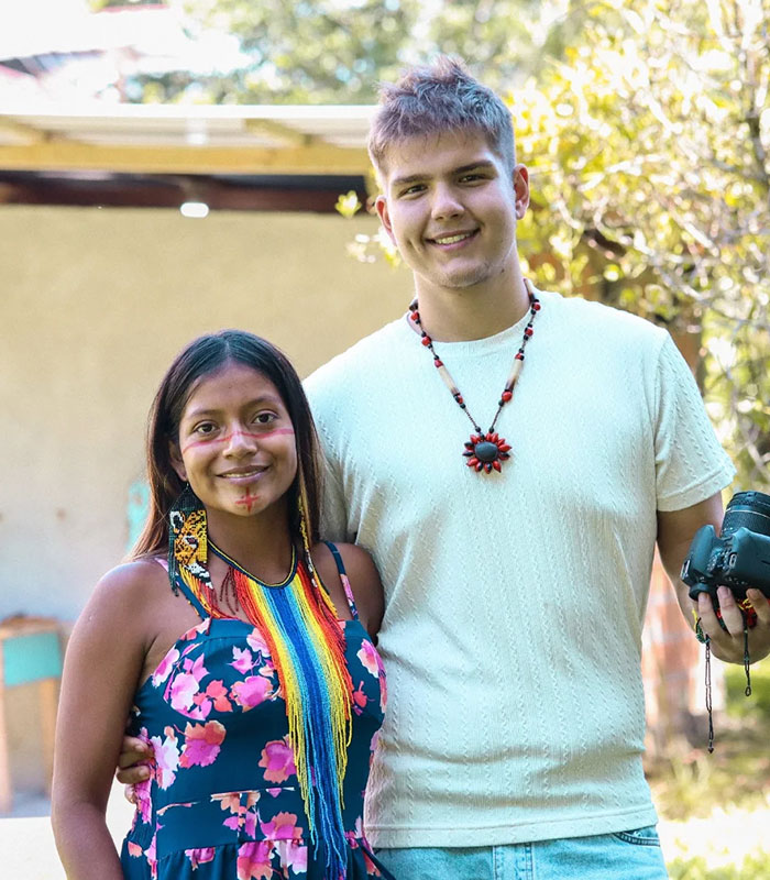 A man and an Amazonian woman from a remote tribe smiling, showcasing their connection and the man's new life. A man and an Amazonian woman from a remote tribe smiling, showcasing their connection and the man's new life.