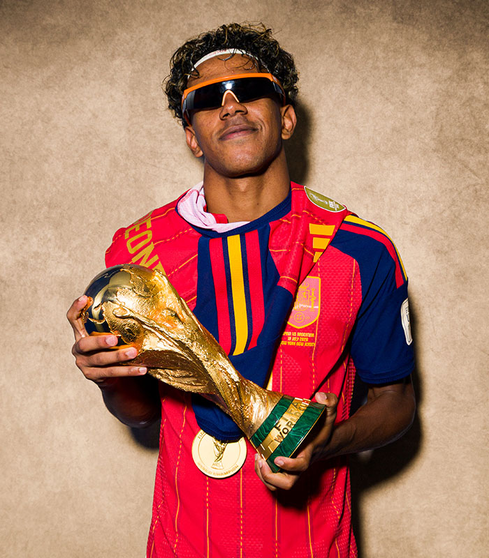 World Cup Hero Lamine Yamal proudly holds the trophy after his final win, sunglasses on. World Cup Hero Lamine Yamal proudly holds the trophy after his final win, sunglasses on.