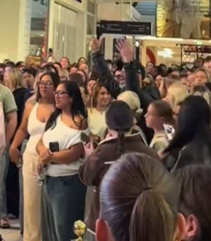A crowd of people looking at a man publicly shamed, accused of attacking a woman. A crowd of people looking at a man publicly shamed, accused of attacking a woman.