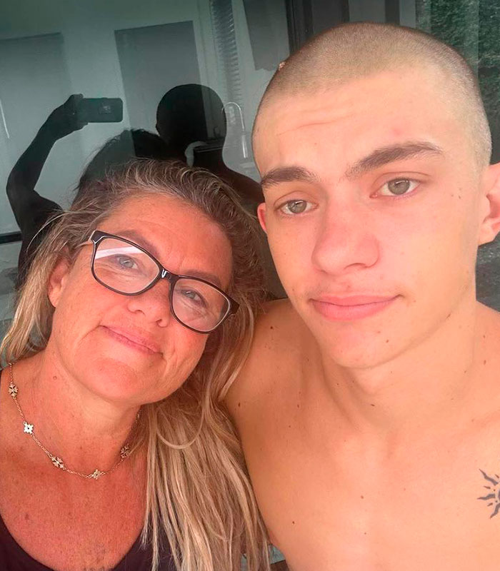 A mom and her teen son in a selfie, central to the story of a teen son facing Thai jail over airport crime.