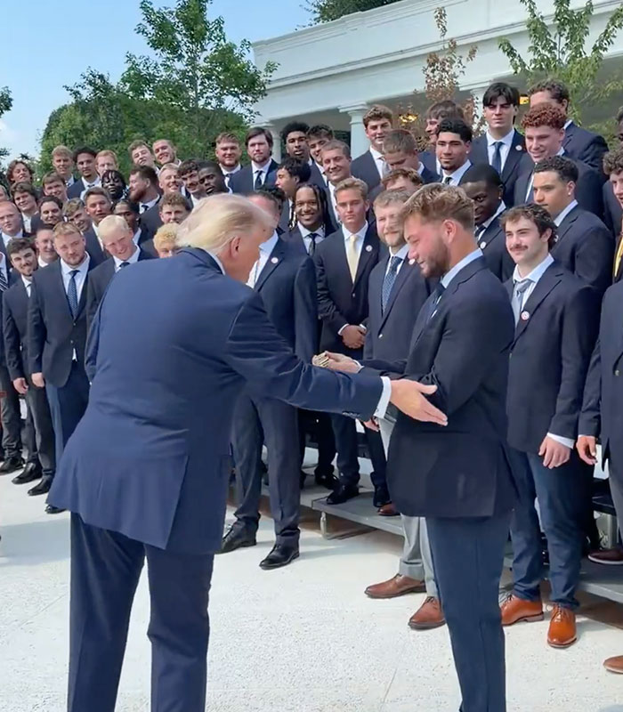 Kindergartener Trump attempts to take an award from an athlete, highlighting his attempts to steal things he didn't win. Kindergartener Trump attempts to take an award from an athlete, highlighting his attempts to steal things he didn't win.