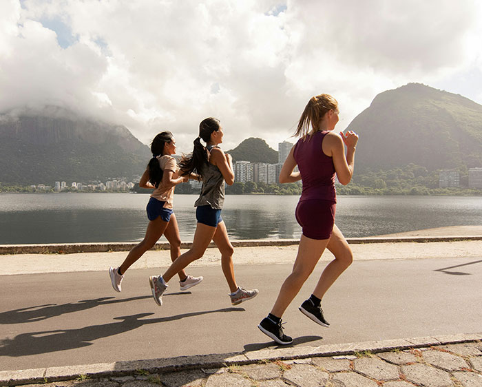 Three women running outdoors, showing how different body fat percentages can transform their faces. Three women running outdoors, showing how different body fat percentages can transform their faces.