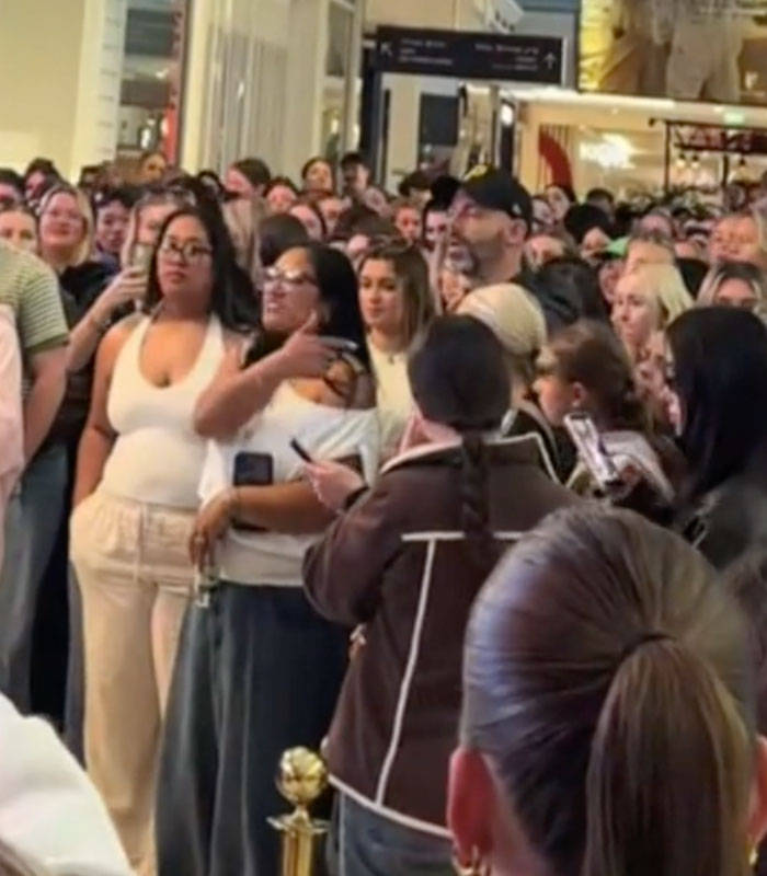 A crowd looking at a woman's scheme failing, leading to public shaming. A crowd looking at a woman's scheme failing, leading to public shaming.