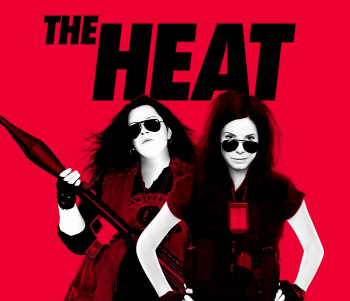 A movie poster for The Heat, depicting two women, relevant to the critique of beauty standards and photoshop.