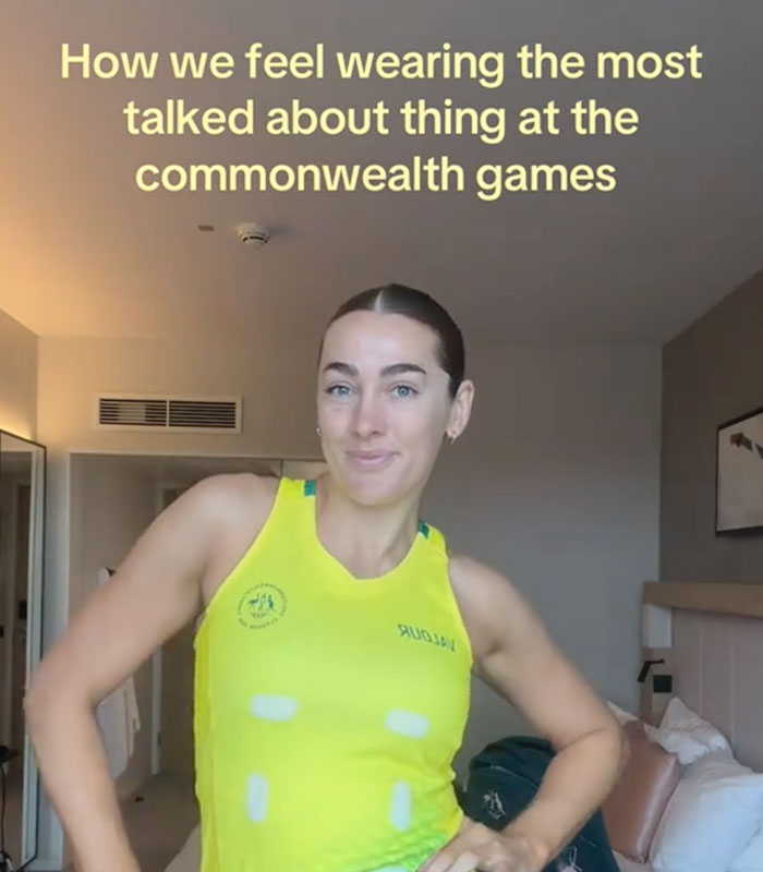 Female Australian team athlete showcasing the wardrobe fail at the Commonwealth Games, looking at the camera.