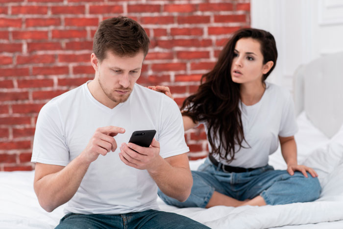 A cheating wife with a concerned partner looking at a phone, suggesting an affair or contact with the other man. A cheating wife with a concerned partner looking at a phone, suggesting an affair or contact with the other man.