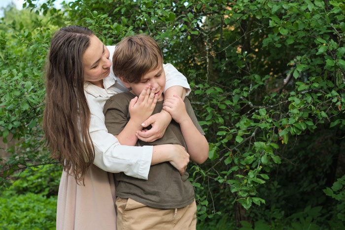 A mother comforting her child who drank alcohol-spiked cola.