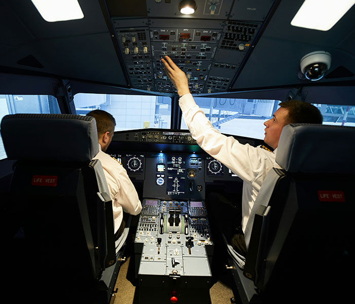 Pilots in a cockpit, demonstrating flight control and the impact of turbulence on handling flights. Pilots in a cockpit, demonstrating flight control and the impact of turbulence on handling flights.
