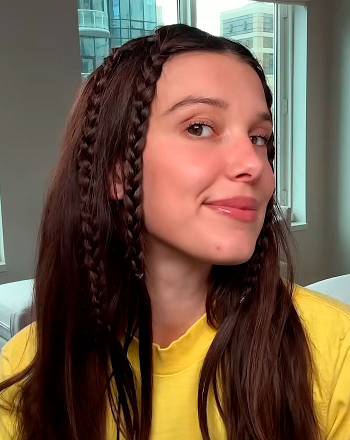 Millie Bobby Brown with braided hair and a casual yellow shirt, sparking sheer look bandwagon discussion. Millie Bobby Brown with braided hair and a casual yellow shirt, sparking sheer look bandwagon discussion.