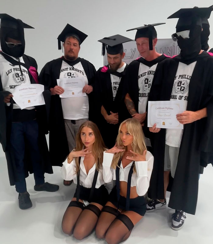 Two women posing in schoolgirl outfits with men in graduation gowns, linked to the bedroom mistake discussion. Two women posing in schoolgirl outfits with men in graduation gowns, linked to the bedroom mistake discussion.