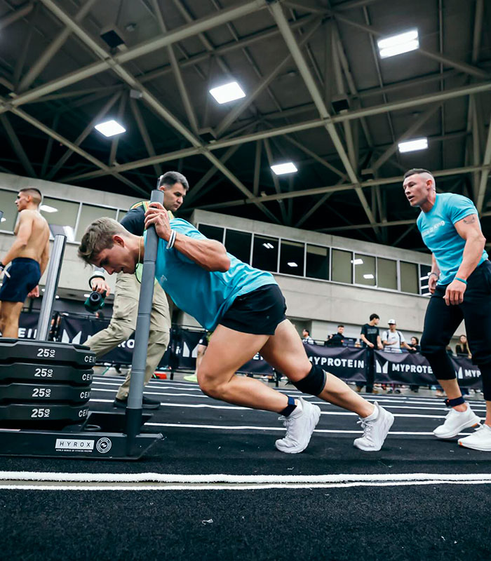 Men pushing weights in a gym, an example of men-only gyms and physical activity for Christian men.
