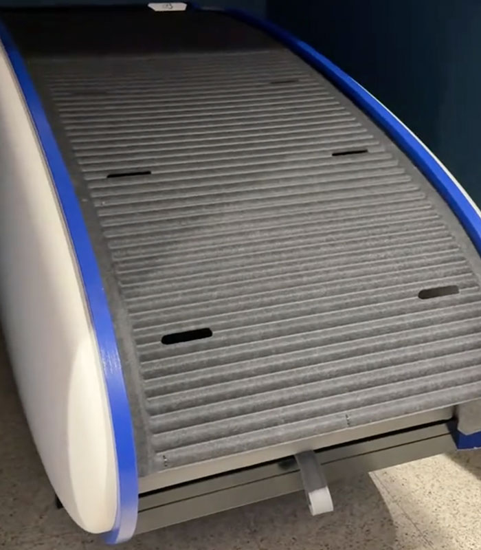 A futuristic airport sleeping pod with a retractable bed, demonstrating its compact design and functionality for travelers. A futuristic airport sleeping pod with a retractable bed, demonstrating its compact design and functionality for travelers.