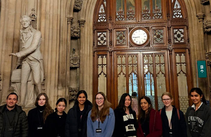 The all-female chess team poses together in a grand hall, celebrating their achievements in the chess community. The all-female chess team poses together in a grand hall, celebrating their achievements in the chess community.