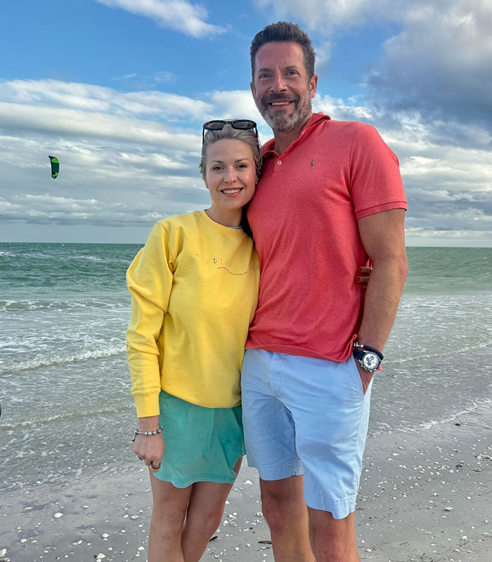A man and woman smiling on a beach, against a backdrop of the ocean and sky, amidst details of a cheating son-in-law. A man and woman smiling on a beach, against a backdrop of the ocean and sky, amidst details of a cheating son-in-law.