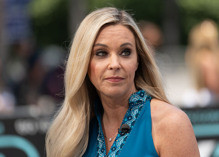 Kate Gosselin with blonde hair and a blue top, looking concerned as Collin Gosselin slams mom.