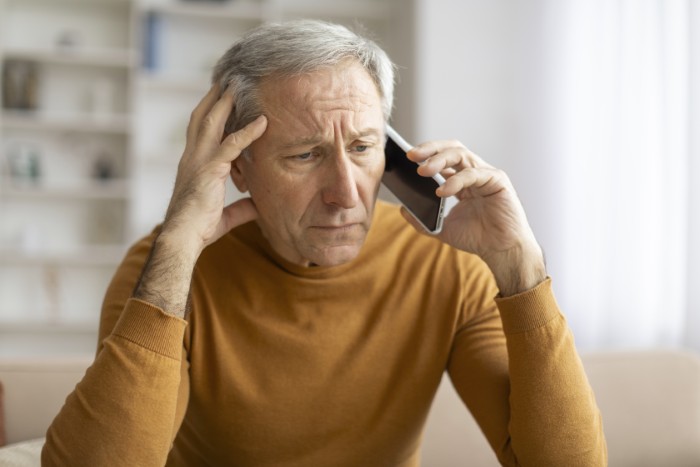 Man denies aunt money, feeling wrong. An older man on a phone call, looking distressed, hands on his head. Man denies aunt money, feeling wrong. An older man on a phone call, looking distressed, hands on his head.