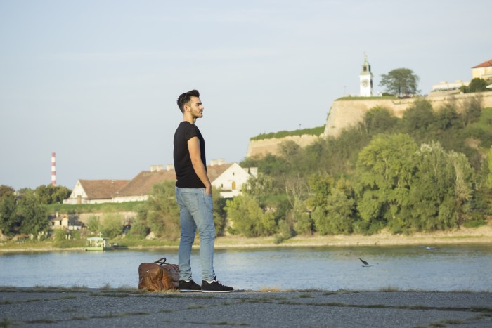 A man looks at a river, contemplating the matter with his aunt asking him money. A man looks at a river, contemplating the matter with his aunt asking him money.