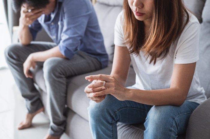 A distressed woman takes off her wedding ring after walking into her home and seeing her husband and her sister completely naked.