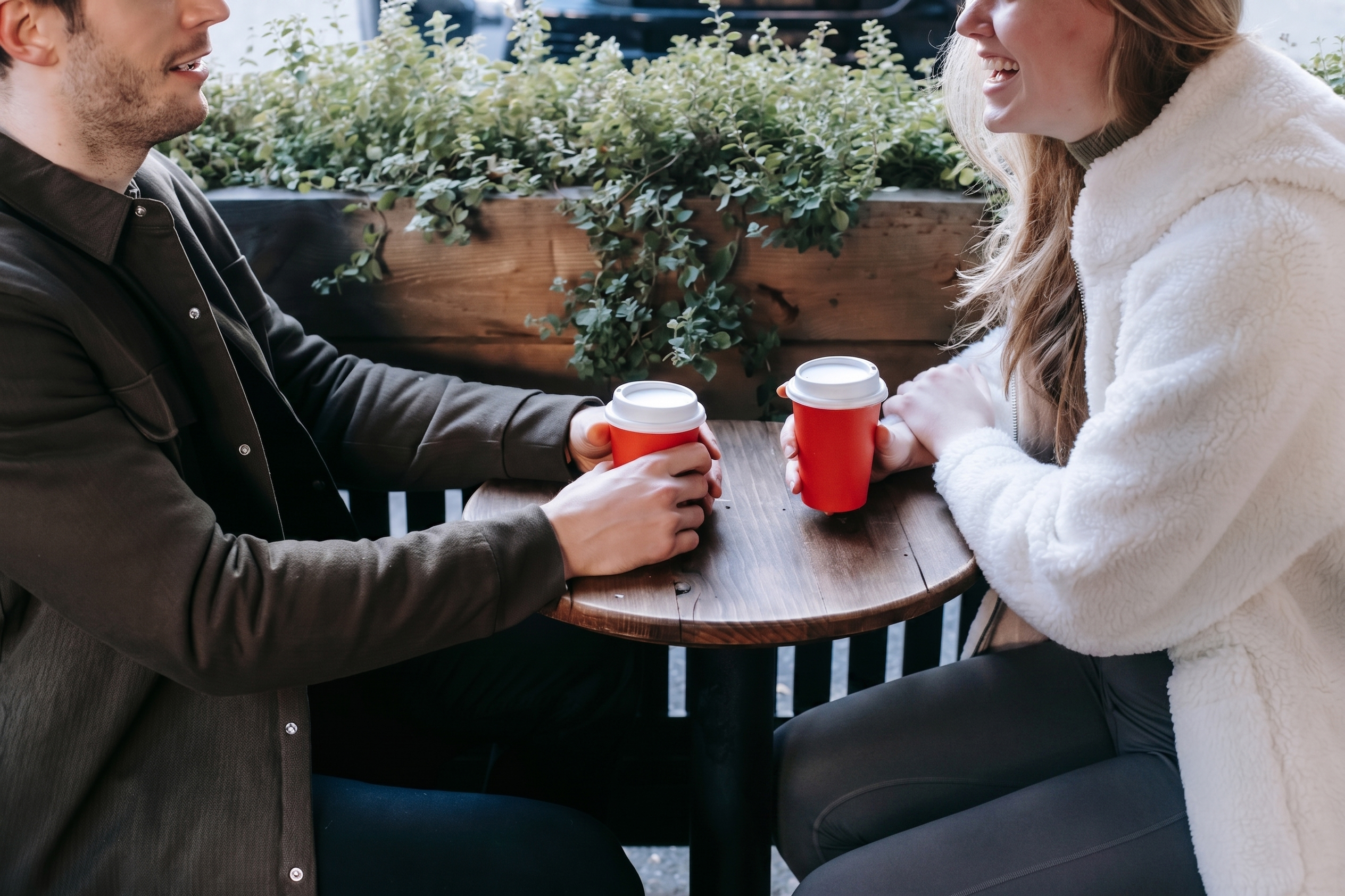 A baffled woman and a guy on a date, sitting at an outdoor cafe with coffee cups, discussing his theory. A baffled woman and a guy on a date, sitting at an outdoor cafe with coffee cups, discussing his theory.